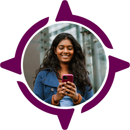 young women typing on her cellphone in an outdoor urban setting